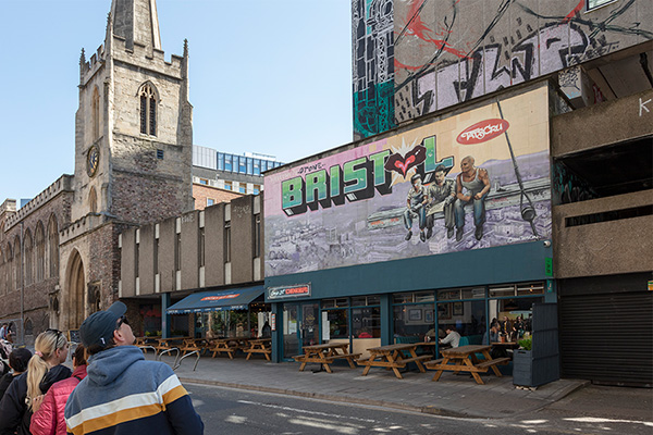 Collage of Bristol's colorful houses, harbor, and street art